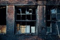 Broken window of burnt red brick building Royalty Free Stock Photo
