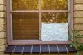 Broken window with cardboard Royalty Free Stock Photo