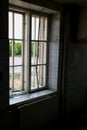 Broken window, dark room and view out