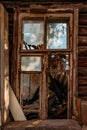 Broken window of old abandoned wooden building Royalty Free Stock Photo
