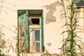 Broken window in old rustic wall with green shutter Royalty Free Stock Photo