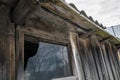 Broken window by an old wooden utility shed