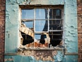 A broken window in the wall of a dilapidated and abandoned house. Royalty Free Stock Photo