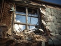 A broken window in the wall of a dilapidated and abandoned house. Royalty Free Stock Photo