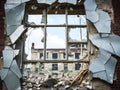 A broken window in the wall of a dilapidated and abandoned house. Royalty Free Stock Photo