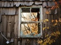 A broken window in the wall of a dilapidated and abandoned house. Royalty Free Stock Photo