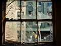 A broken window in the wall of a dilapidated and abandoned house. Royalty Free Stock Photo