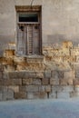 Broken windows and grunge stone bricks wall in abandoned Darb El Labana district Royalty Free Stock Photo