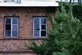 Broken windows in a house and a run-down house. Ruin. Day Royalty Free Stock Photo