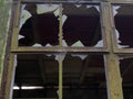 Broken windows with jagged glass in derelict old abandoned building Royalty Free Stock Photo