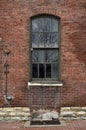 Broken windows in old abandoned brick factory building in city Royalty Free Stock Photo