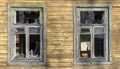 Broken windows in an old wooden ruined house, barrack, ruins