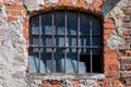 Broken window with bars in the old wall Royalty Free Stock Photo