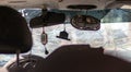 Broken windshield as a result of an accident, inside view. Cabin interior details, view from the cab. The icon hangs on the