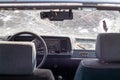 Broken windshield of a car from a bullet, from a shot from a firearm, view from the inside of the cabin. Damaged glass with traces