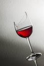 Broken wine glass slant with red wine Royalty Free Stock Photo