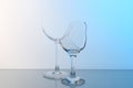 Broken wine glasses on table against light blue gradient background Royalty Free Stock Photo