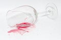 Broken wineglass with spilled splash of red wine Royalty Free Stock Photo