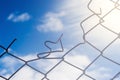 Broken Wire Fence and Blue Sky Background Royalty Free Stock Photo