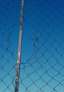 Broken Wire Mesh Fencing with Blue Sky Royalty Free Stock Photo