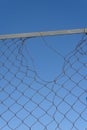 Broken Wire Mesh Fencing with Blue Sky Royalty Free Stock Photo