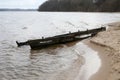 Broken wooden boat on the shore of the lake. Kaunas, Lithuania Royalty Free Stock Photo