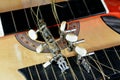 A broken wooden old classic guitar with damaged strings chords, shattered musical instrument, unattached damaged guitar with cut Royalty Free Stock Photo