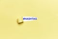 Broken yellow cardboard and the word #HASHTAG appears below