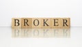 Broker name created from wooden letter cubes. finance and economy.