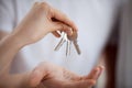 Broker hand holding keys giving to new home owner, closeup Royalty Free Stock Photo