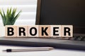 Broker word wooden cubes on the green background