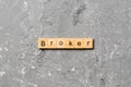 Broker word written on wood block. broker text on cement table for your desing, concept