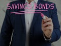 Broker writing SAVINGS BONDS with marker Royalty Free Stock Photo