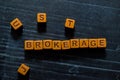 Brokerage on wooden cubes. On table background