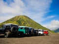 BROMO, INDONESIA - JULY 12, 2O17: Close up of many Jeeps parked in a row with the Mount Bromo in the horizont, the