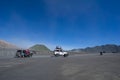 Colourful tourist jeeps in savanna of Tengger caldera