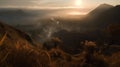 The Bromo mountains landscape during a heavy misty morning with a hint of golden hour is a stunning and atmospheric image that cap