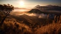 The Bromo mountains landscape during a heavy misty morning with a hint of golden hour is a stunning and atmospheric image that cap