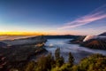 Bromo volcano crater erupt release smoke with twilight sunrise sky background and morning fog landscape at Indonesia Bromo