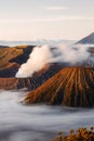 Bromo volcano crater erupt release smoke with twilight sunrise sky background and morning fog landscape at Indonesia Bromo