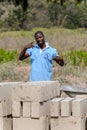 Unidentified Ghanaian man in blue shirt raises his hands and li