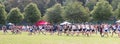 Start of a high school boys cross country running race on a grass field Royalty Free Stock Photo