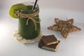 Bronz star, chocolate and green smoothie on a white background