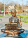 Bronz statue of a children reading a book