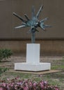 Bronze abstract sculpture on white pedestal by unknown artist outside the World Trade Center in Dallas, Texas. Royalty Free Stock Photo