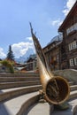 Bronze alphorn sculpture on stairs at Zermatt, Switzerland