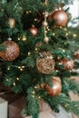 Bronze balls on the Christmas tree close-up. Christmas tree design decorations. The concept of celebrating New Year and