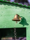 Bronze bell on a side of a green wagon