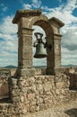 Bronze bell on top of stone wall at the Castle of Trujillo Royalty Free Stock Photo