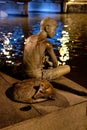 Bronze boy, fishing at Singapore river.